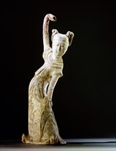 Unglazed pottery figure of a dancing woman