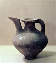 Unglazed jug that resembles in form an oinochoe