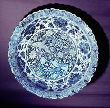 A blue and white plate with representations of the male and female phoenix