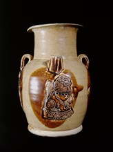 Changsha ewer with a plaque molded in relief of a Buddhist lion seated on a drum