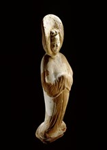 A painted earthenware figure of a lady wearing a voluminous hooded cloak