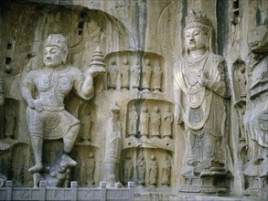 The guardian kings of Buddhism carved on the north wall of the Fengxian temple at the Longmen cave temple complex