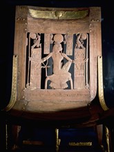 Chair with finely carved wooden surface picked out with gold foil from the tomb of Tutankhamun