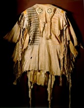 A deerskin war shirt which belonged orignially to a Blood (a Blackfoot sub tribe) chief named Katookinay (No Top Knot)