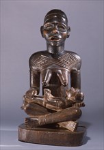 Mother and child carving (phemba) honouring female reproductive poweran idealised image of womens role and by implication of the growth and wealth of the kingdom