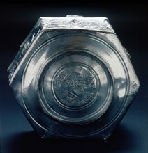 The base of a six sided silver vessel which is marked by a control stamp