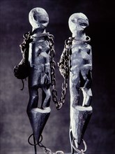 The chains on this double figured Fon bocio are both a symbol of Gu, the vodu of iron and war and an image of slavery