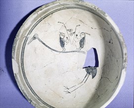 Pottery bowl with design of figures on the back of a waterbird