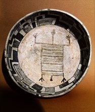 Pottery bowl with schematic human figure and black on white geometric design