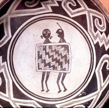 Pottery bowl with schematic human figures and black on white geometric design