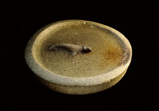 Unusual seal oil lamp with a seal apparently swimming in a pool of oil