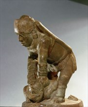 Soapstone pipe generally assumed to depict a warrior beheading his victim