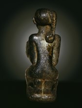 Figure in the form of a kneeling girl holding a miniature cosmetic jar for kohl (eye paint)