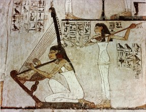 A detail of a wall painting in the tomb of Rekhmire showing women playing the harp, lute and tambourine