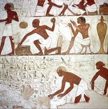 A detail of a wall painting in the tomb of Rekhmire showing metal workers shaping vessels