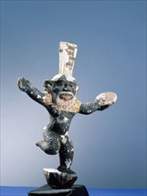 Bes, protector of women in childbirth, dancing with a tambourine to amuse other gods or to ward off evil spirits