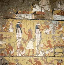 A detail of a painting in the tomb of Ipy depicting carpenters and painters finishing two anthropoid coffins