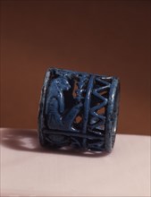 A blue faience amuletic finger ring with figures of Thoth, Horus and Isis incorporated in the design