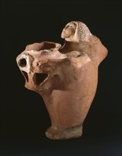 Terracotta vessel in the form of a woman carrying a vase