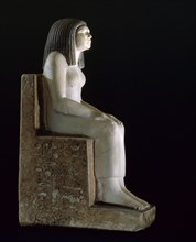 A statue of a seated woman, the royal acquaintance Nynefert min, the wife of an official