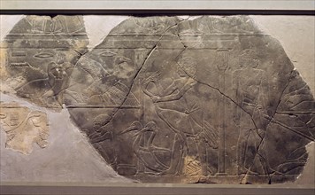 A relief fragment depicting men force feeding cranes