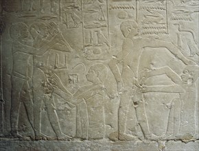 A detail of a relief in the tomb of Ankhmahor at Saqqara depicting a priest performing ritual circumcision on a young boy