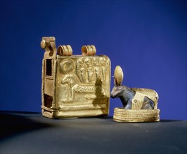 Lapis lazuli amulet of a walking ram, symbol of the god Amun, with gold solar disc crown, base and shrine case