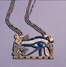 A pendant from the tomb of Tutankhamun in the form of a Wedjat eye, symbol of protection, flanked by the vulture goddess, Nekhbet and the snake goddess Wadjet, protectors of Upper & Lower Egypt