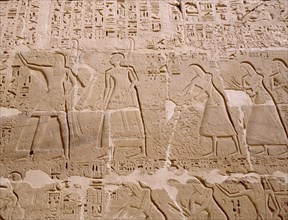 Relief depicting priests scribes and captives being presented to Ramesses III, from his mortuary temple