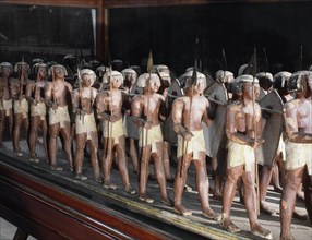 Wooden model of a troop of forty Egyptian soldiers carrying shields and lances