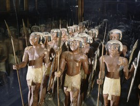 Wooden model of a troop of forty Egyptian soldiers carrying shields and lances