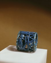 A blue faience amuletic finger ring with figures of Thoth, Horus and Isis incorporated in the design