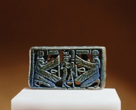 The reverse of a blue faience spacer bead