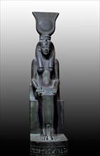 A statue of Isis, sister wife of Osiris, god of the dead, seated on a throne