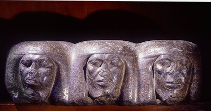 A base of a royal statue which shows the heads of prostrate captives