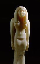 An alabaster statue of a woman wearing a heavy wig