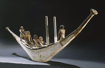A model of a rowing boat with crew and two steering posts