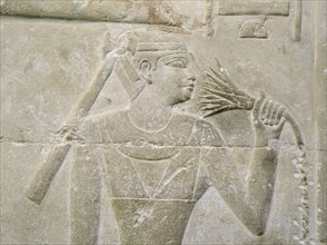 A relief in the tomb of Mereruka depicting a person sniffing a lotus blossom