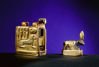 Lapis lazuli amulet of a walking ram, symbol of the god Amun, with gold solar disc crown, base and shrine case