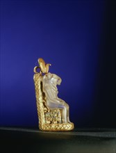 Quartz amulet of the lion headed goddess Bastet seated on a gold throne