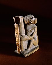 Container for kohl in the form of a cylindrical pot held by a seated monkey
