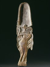 Cosmetic spoon in the form of a young woman in a papyrus thicket supporting a vessel heaped with unguent