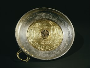 Silver bowl with gold handle and inset repousse gold centre, decorated with an aquatic scene showing four young girls swimming amongst lotus flowers and fish