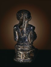 Figure in the form of a kneeling girl holding a miniature jar for kohl (eye paint)