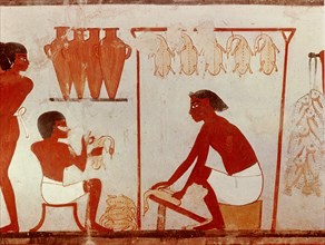 A detail of a painting from the tomb of Nakht depicting the plucking and dressing of poultry after a hunt