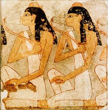 Fragment of a wall painting showing two kneeling women with lotus flowers
