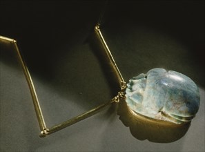 Heart scarab pendant, inscribed on reverse with chapter 26 of the Book of the Dead, from the tomb of General Wen Djeba En Djed, senior official of Psusennes I