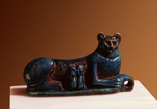 An amuletic spacer bead in the form of a reclining cat