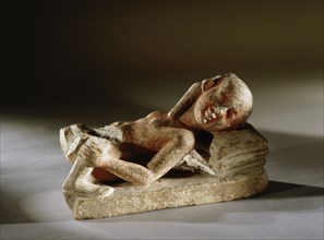 A reclining prostitute with one leg of her client remaining