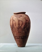 An urn decorated with a design of stylised giraffes